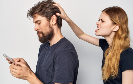cheerful young couple with phones in hands technology emotions Studioの写真素材