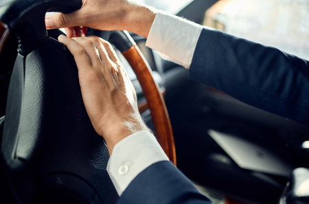 business man in a suit driving a car trip road passengerの写真素材