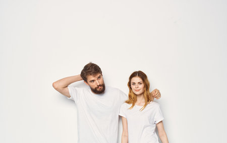 Man and woman stand next to t-shirts family casual wear lifestyle