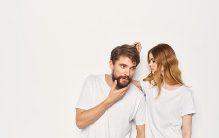 Family couple in white t-shirts fun emotions hug studio cropped viewの写真素材