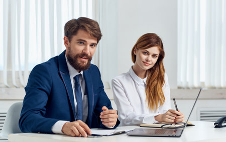 Business man and woman in shirt with laptop at the table in the office staff officeの写真素材