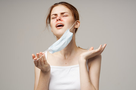 woman with medical mask runny nose infection cold health problemsの写真素材