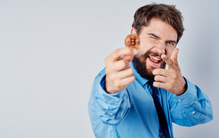 man with a coin in his hands emotions success joy wealth cryptocurrency bitcoin