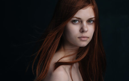 Pretty woman attractive look naked shoulders dark background
