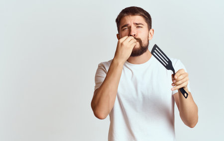 Bearded man shoulder blade hands preparing food white t-shirtの写真素材