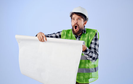 Man in working form blueprints professional security project