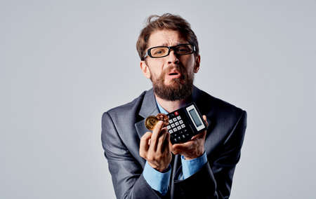cryptocurrency bitcoin calculator man business suit currencyの写真素材