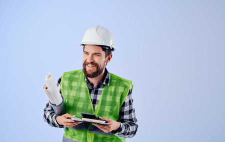 Builder in white helmets construction engineer blueprints work professional blue backgroundの写真素材