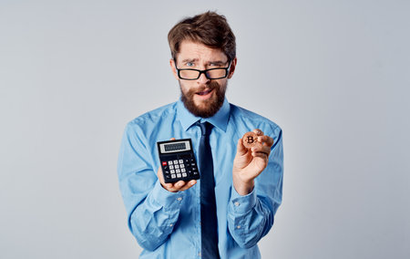 man holding calculator cryptocurrency bitcoin financial market economy technologyの写真素材