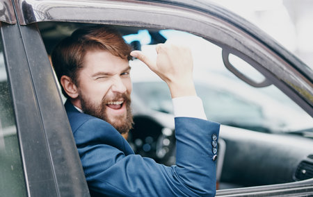 business man peeking out of the car window trip professionalの写真素材