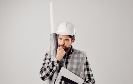 Man builder white helmet blueprints construction work