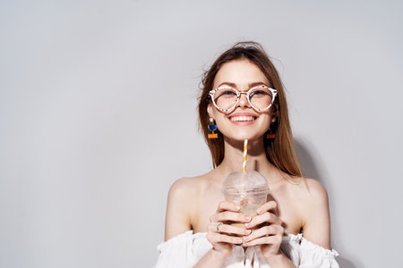 cheerful woman with glasses drink in hands luxury close-upの写真素材