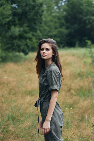 woman in the forest looking at the camera and gray jumpsuitの写真素材