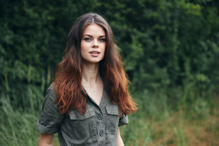 woman in the forest Attractive look long hair Green shirt nature fresh airの写真素材