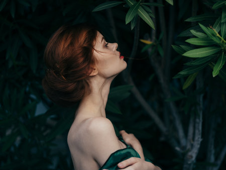 Pretty woman glamor green leaves luxury posing outdoorsの写真素材