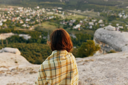 Woman with a blanket on her shoulders fresh air travel tourism village high stonesの写真素材