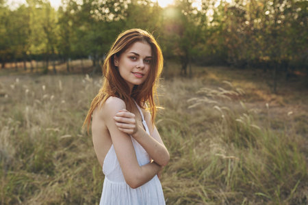 happy woman lifestyle field grass trees summer vacationの写真素材
