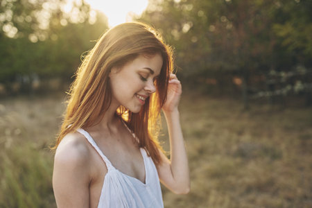 attractive woman outdoors in the garden sunset fresh air treesの写真素材