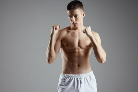 guy are boxing on gray background and naked torso muscle bodybuilderの写真素材