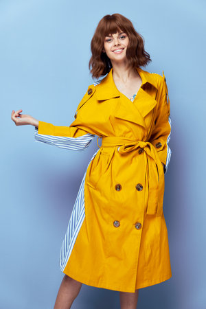Woman Smile hand in pocket yellow striped coatの写真素材