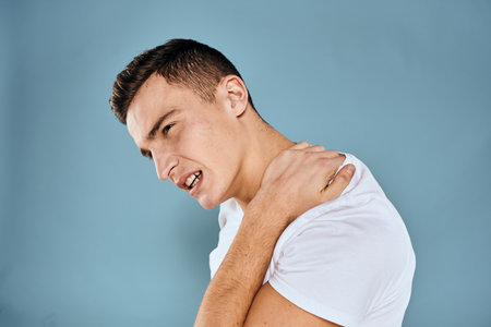 Man gestures with his hands emotions white t-shirt expression blue backgroundの写真素材