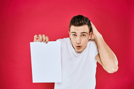 emotional man holding a sheet of paper copy space t-shirt red background