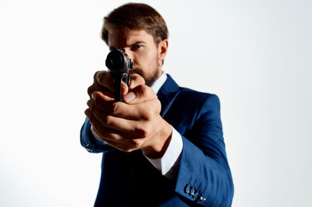man in suit holding a gun detective danger lifestyle work