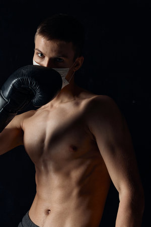 boxer gloved naked torso muscle fitness black background circumcisionの写真素材