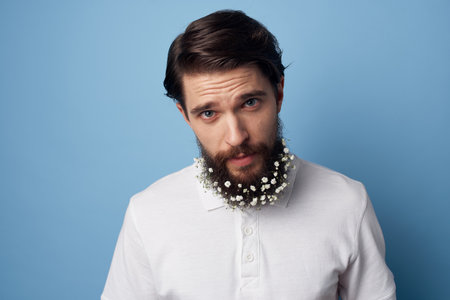 cute man flowers in beard t-shirt emotions blue backgroundの写真素材