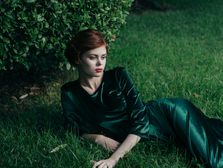 Woman in green dress lies on the grass nature luxury Gothic Princessの写真素材