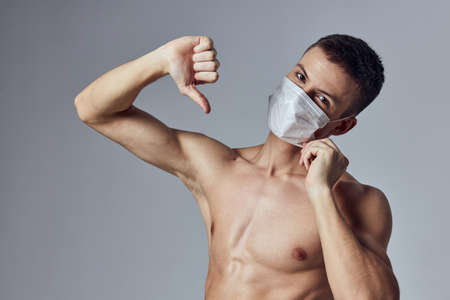 sport man showing thumb down medical mask health workout