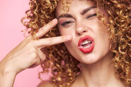 Beautiful woman Makeup on the face and two fingers fashion background