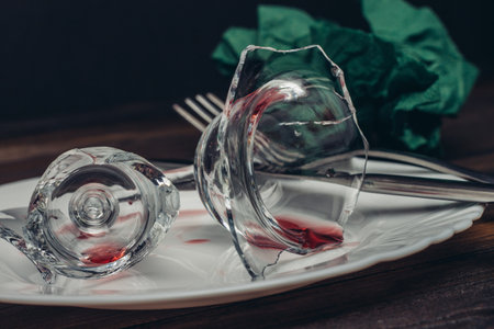broken wine glass on a plate kitchenware wooden table