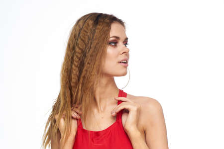 Pretty woman red tank top wavy hair attractive look hotel lifestyle light background