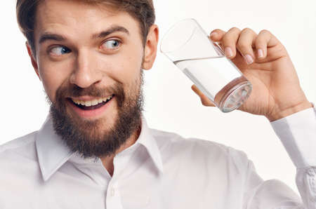 portrait of a man with a glass of transparent water healthy lifestyle drinkの写真素材