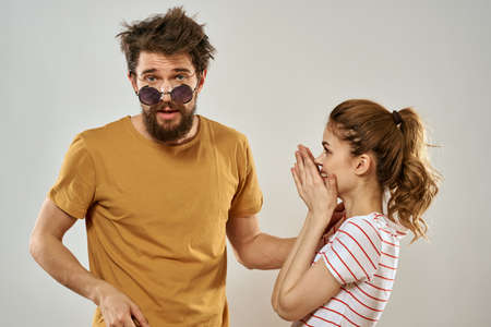 man in sunglasses next to woman in striped t-shirt emotions communication fashion studio funの写真素材