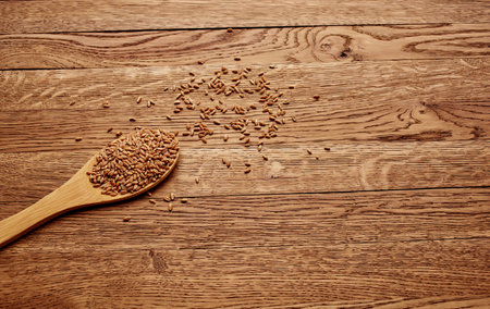 Spoon and cereal products flakes on a wooden table cooking background texture imageの写真素材