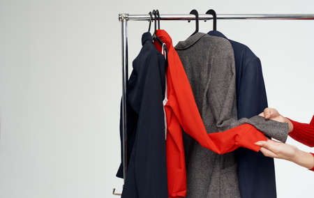 Woman dressing room near fashionable clothes on a light background jacket suitの写真素材