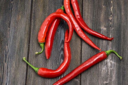 hot chili peppers red wooden table cooking food ingredients