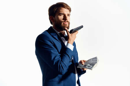 rich man with gun and wad of money classic suit white background