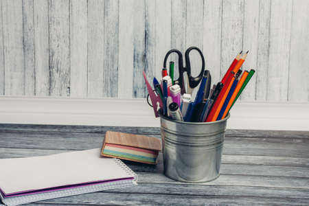 office desk with stationery and pencils scissors paper markers