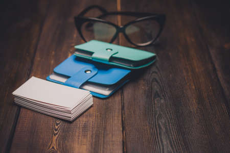 glasses business cards wallet wooden background and texture finance officeの写真素材