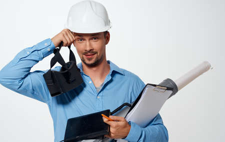 Architect builder in a white helmet with a tube and documents 3D glasses modelの写真素材