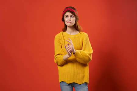 cheerful red-haired woman in yellow sweater emotions streetwear fashion red backgroundの写真素材