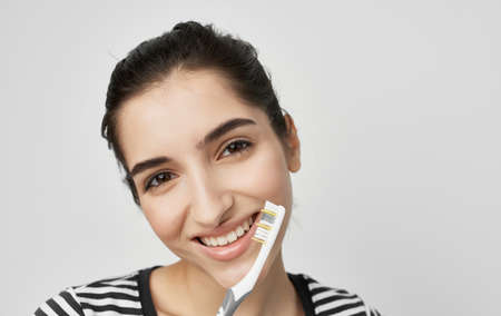 woman in striped t-shirt toothbrush oral hygiene health