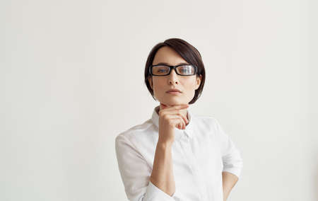 Business woman in glasses documents or in hands on light background