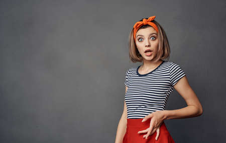 pretty woman in striped t-shirt bandage orange on her head fashion emotionsの写真素材