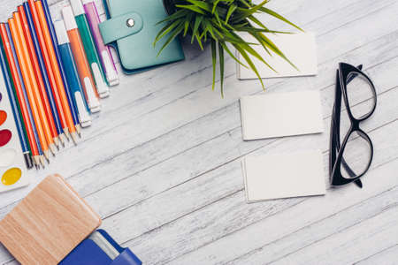 business cards office glasses stationery colored pencils markers notepads flower in a potの写真素材