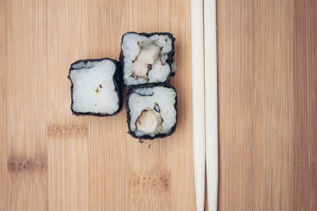sushi rolls chopsticks food ration delicacy wood board japanese cuisineの写真素材