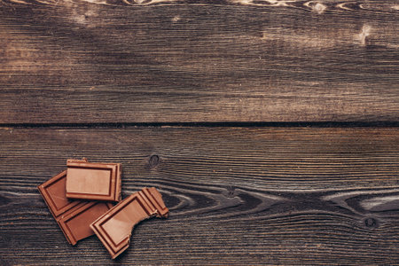 bitten brownie chocolate on wooden background textureの写真素材